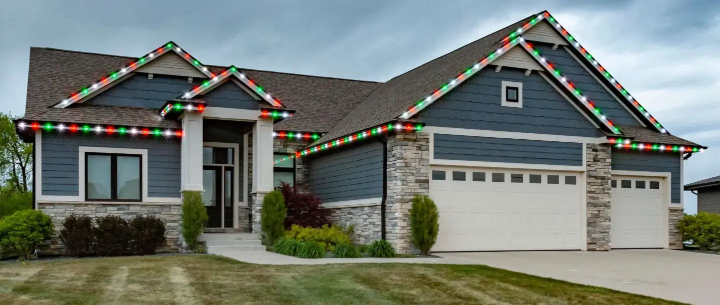 Modern home with permanent color-changing LED lights installed along the roofline.